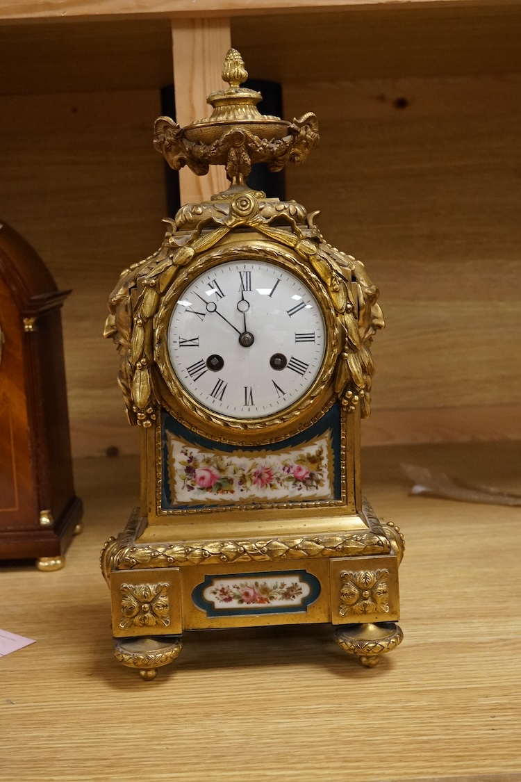 A 19th century French ormolu mantel clock with email dial and hand painted panels, with pendulum, no key, 39cm high